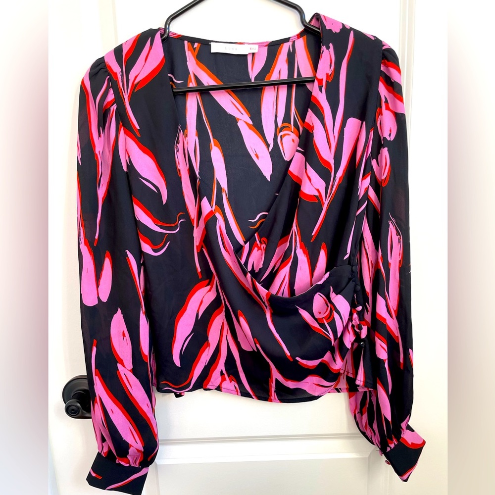 Beautiful Lush brand pink, red and black blouse with ruching detail on the side.